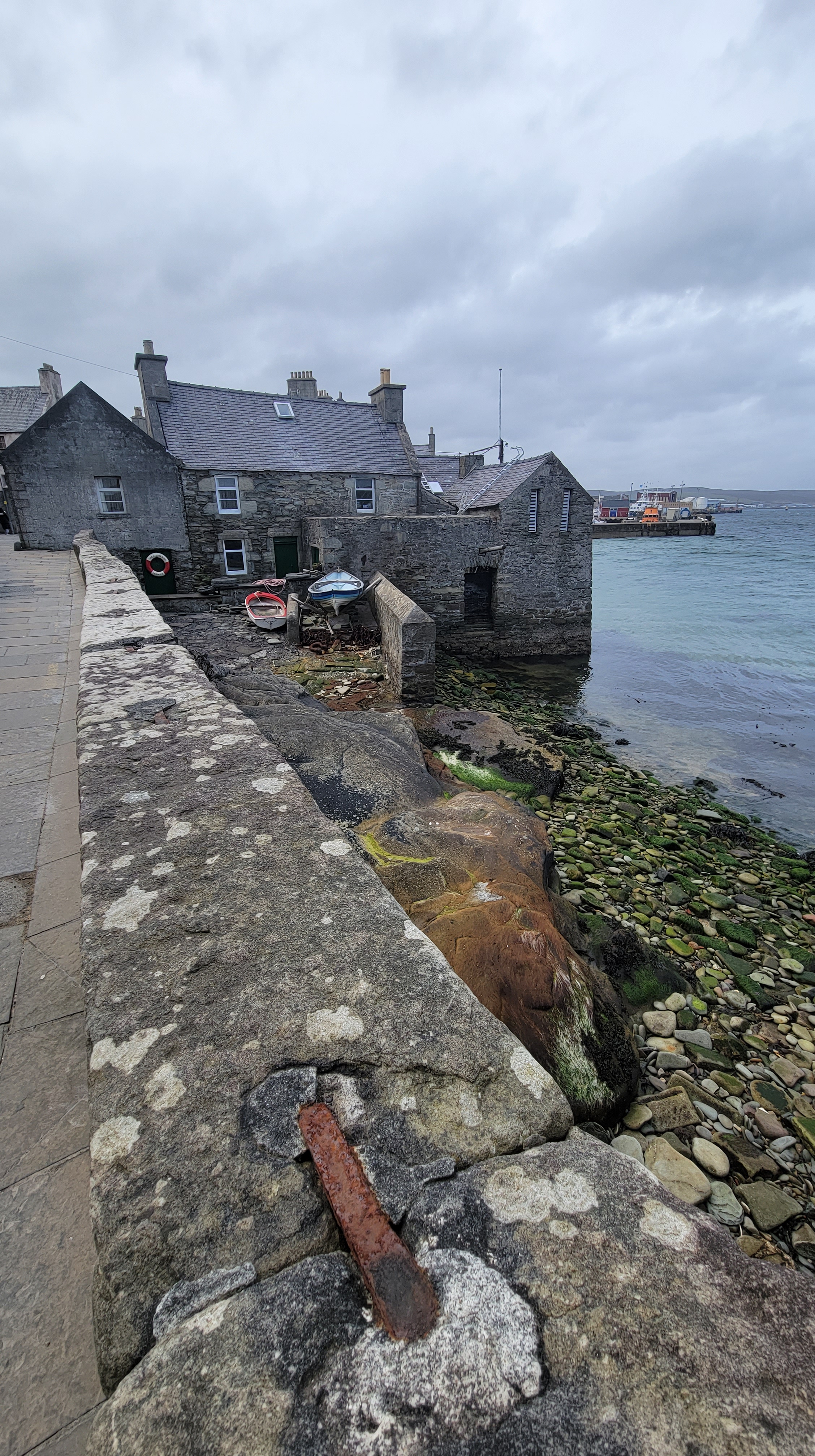 A stone house that lives partially in the sea in Lerwick, Shetland Islands.